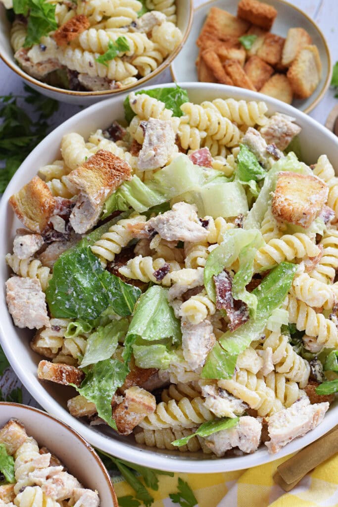 Chicken pasta salad in a white bowl.