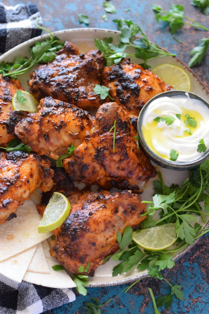 Yogurt marinated chicken on a plate.