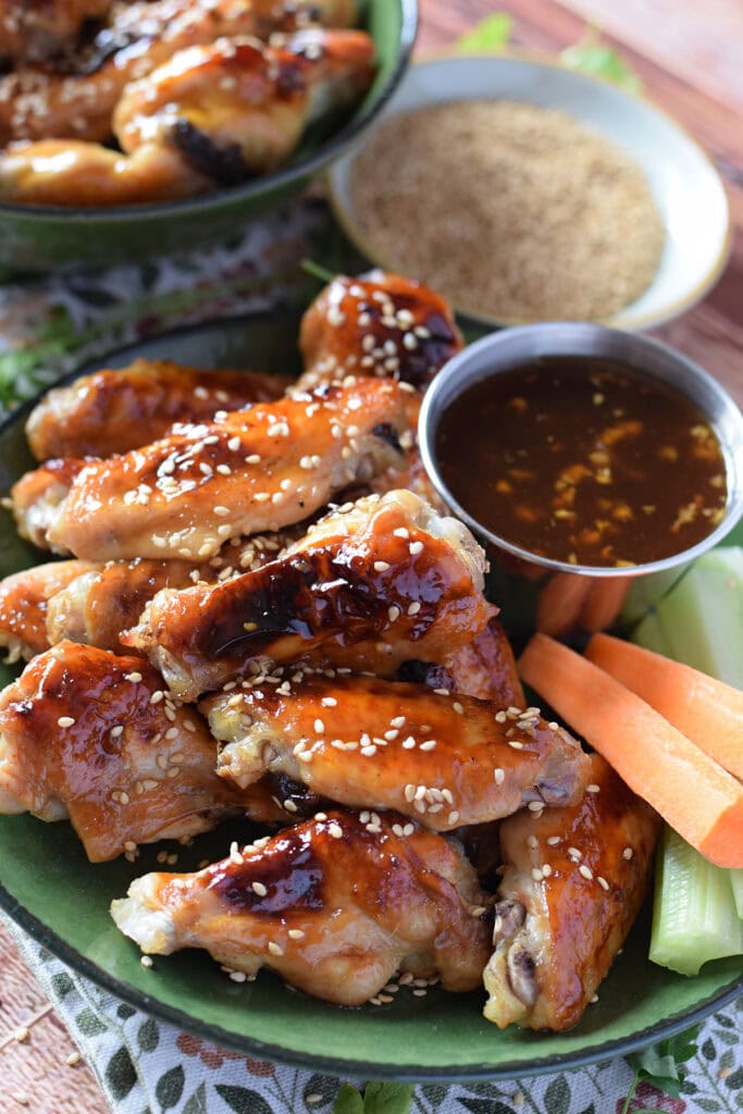 Baked teriyaki chicken wings with carrots on the side.