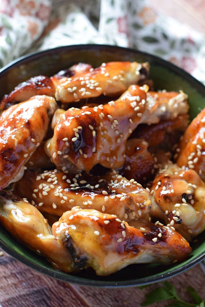 Close up of teriyaki wings in a bowl.