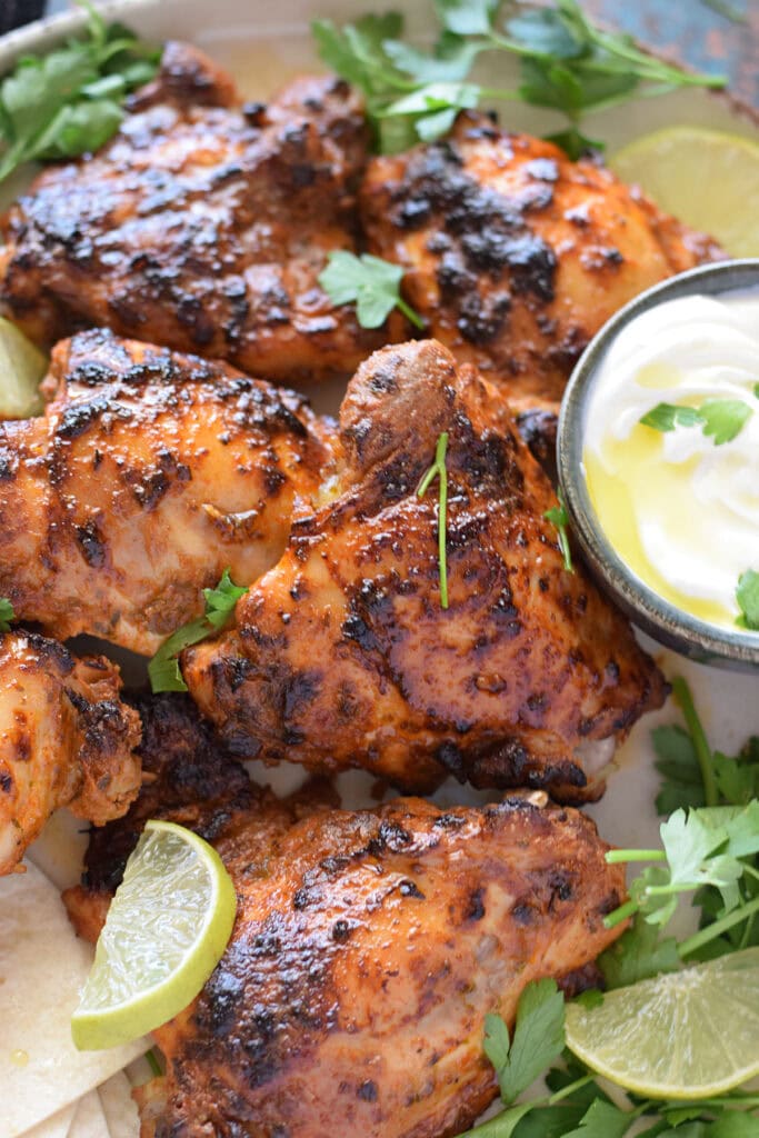 Marinated chicken close up with limes.
