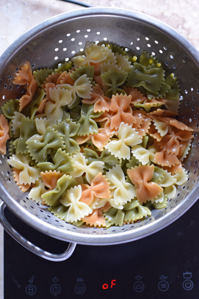 Bowtie pasta in a colander.