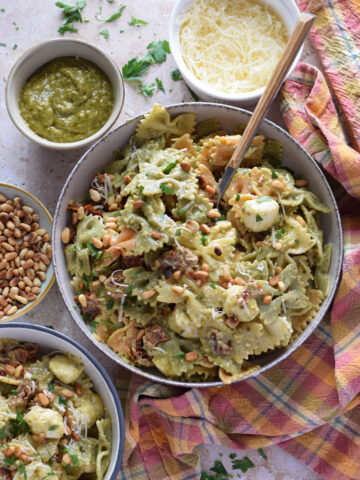Green pesto pasta salad in serving bowls.