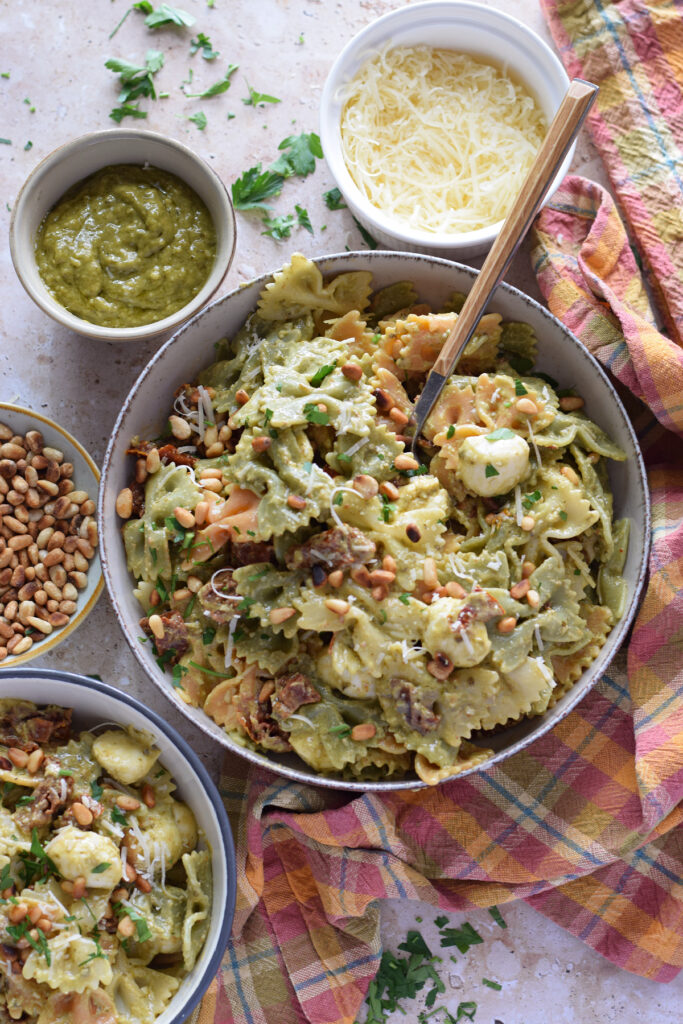 Green pesto pasta salad in serving bowls.