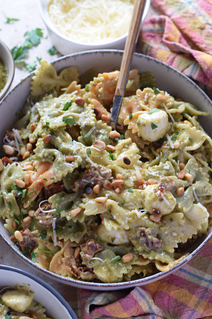Close up of a pesto pasta salad.