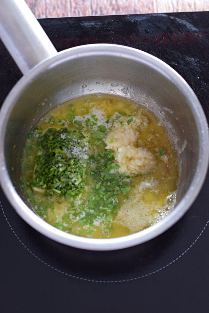 Making garlic butter in a small saucepan.