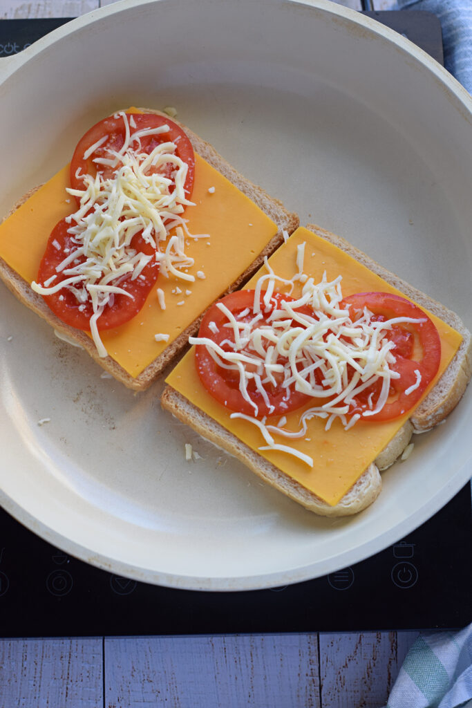 Making a grilled cheese sandwich in a skillet.
