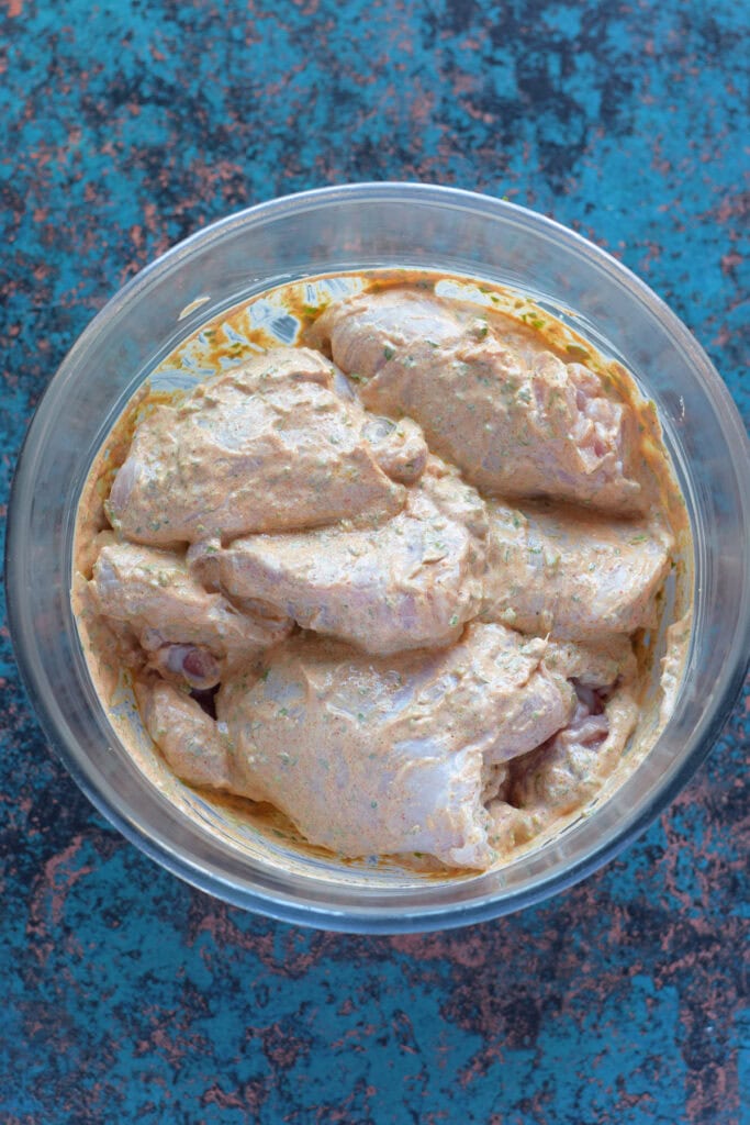 Chicken marinade in a glass bowl.