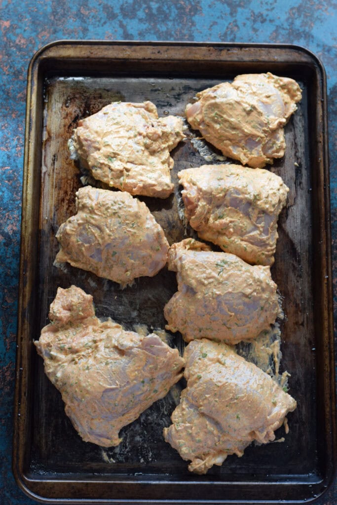 Chicken on a baking tray.