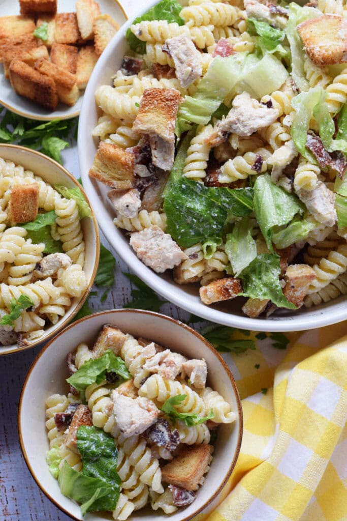 Pasta salad with chicken in a white bowl.