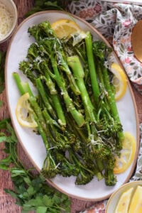 Roasted tender stem broccoli on an oval serving dish.