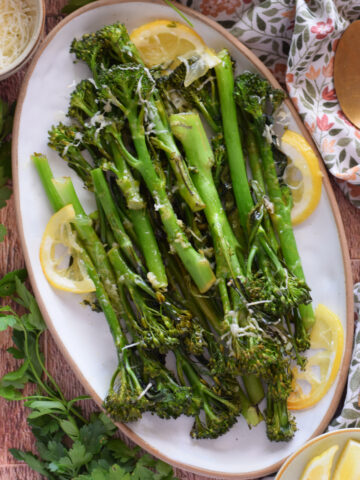 Roasted tender stem broccoli on an oval serving dish.