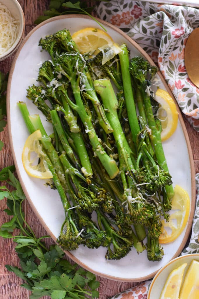 Roasted tender stem broccoli on an oval serving dish.