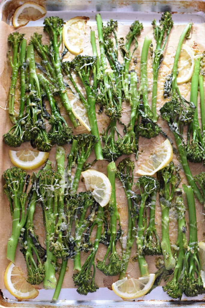 Roasted broccolini on a baking tray.