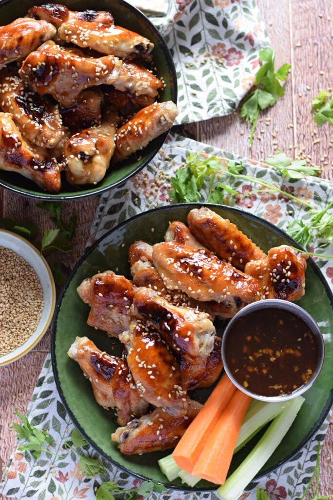 Baked teriyaki chicken wings with carrots and celery.