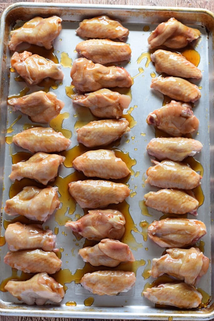 Ready to bake chicken wings on a baking tray.