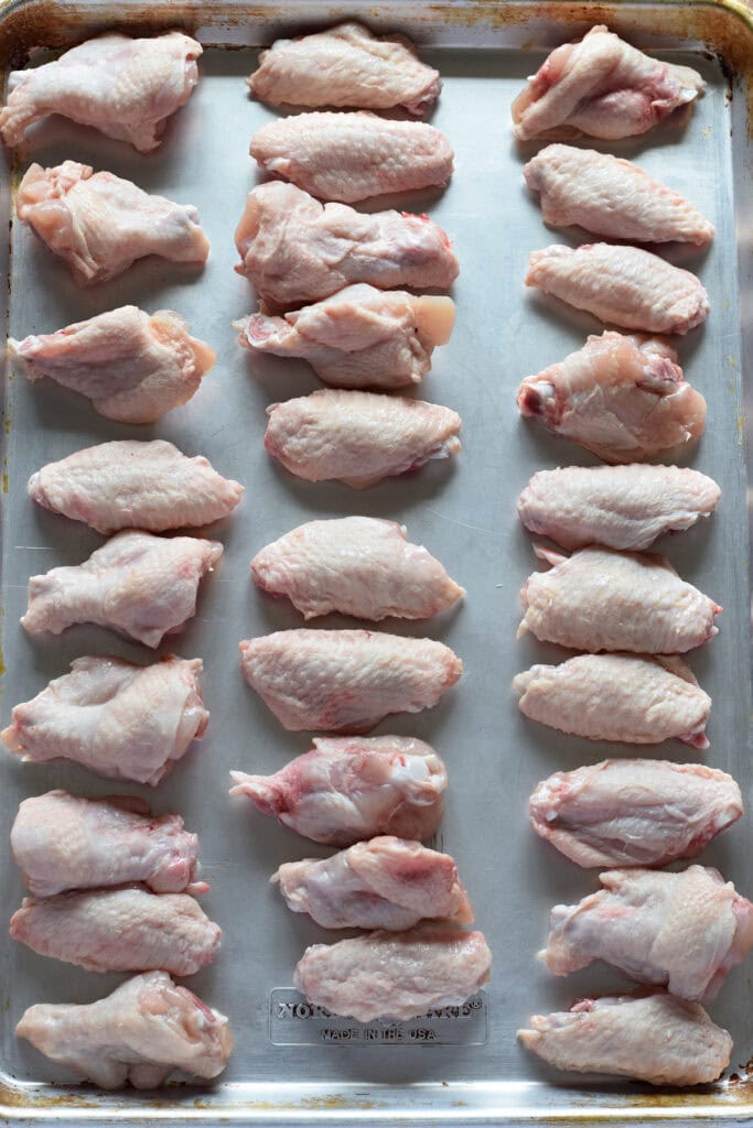 Chicken wings on a baking tray.