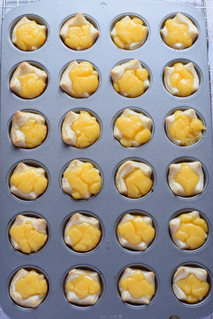 Baked lemon puffs in a mini muffin tin.