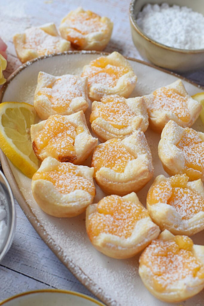 Lemon puss in a white serving plate.
