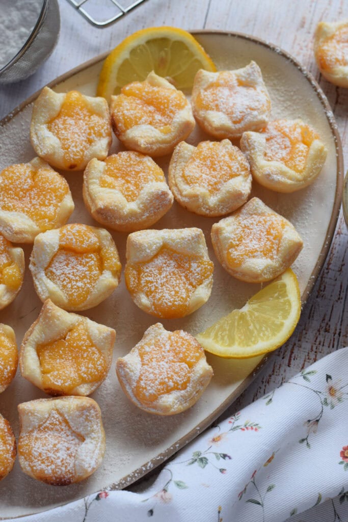Lemon filled puff pastry on a white serving plate.