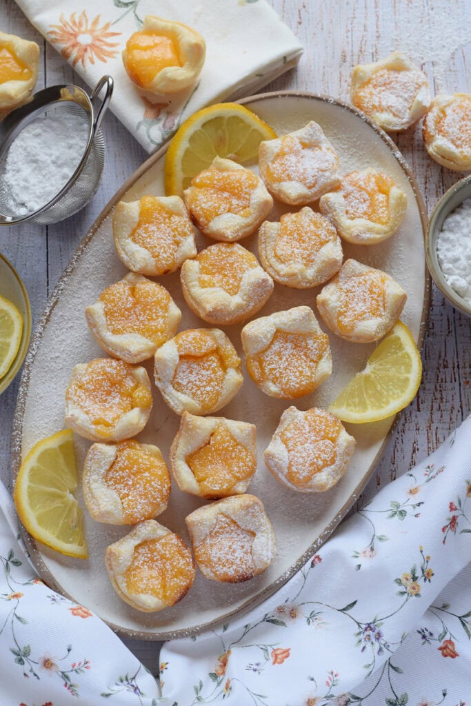 Lemon filled puff pastry on a white serving plate.