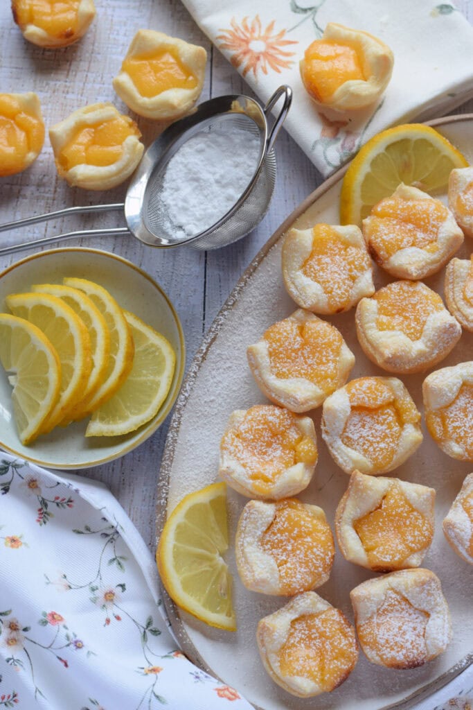 Lemon puff pastry bites on a serving dish.