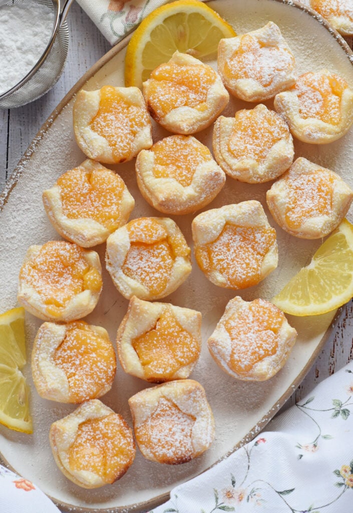 Lemon filled puff pastry on a whtie plate.