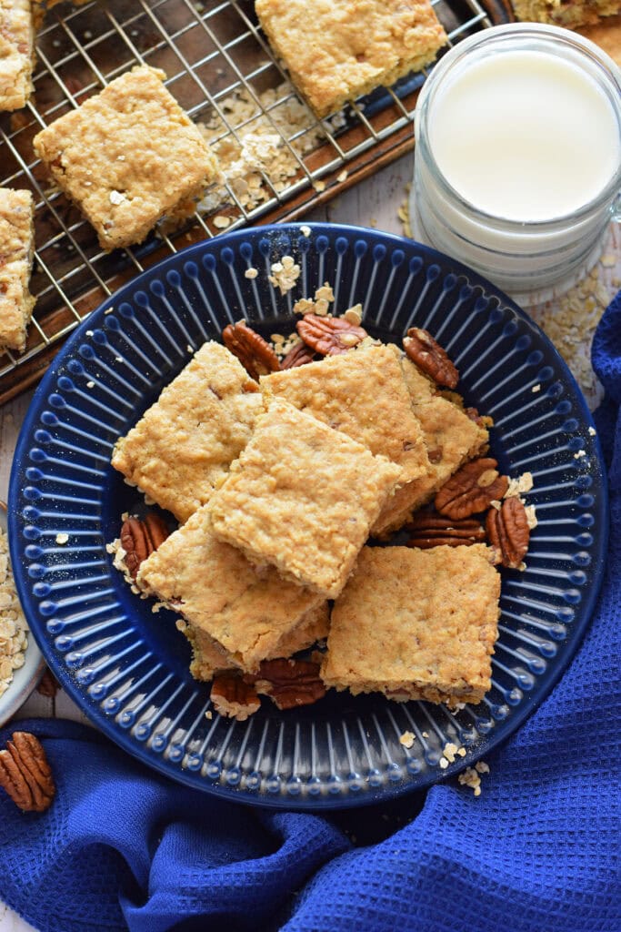 Oatmeal pecan bars on a blue plate.