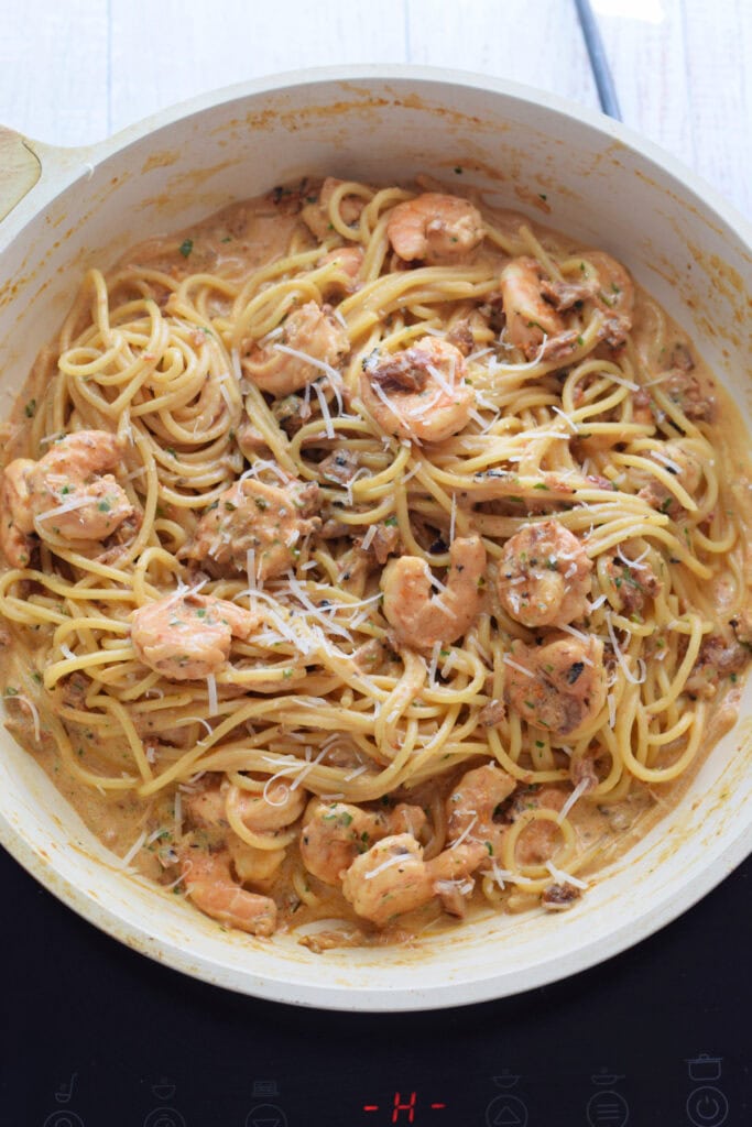 Creamy shrimp and pasta in a skillet.