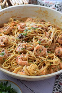 Close up of shrimp pasta with sun dried tomatoes.