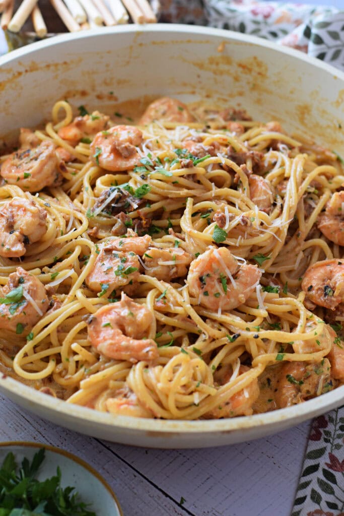 Close up of shrimp pasta with sun dried tomatoes.