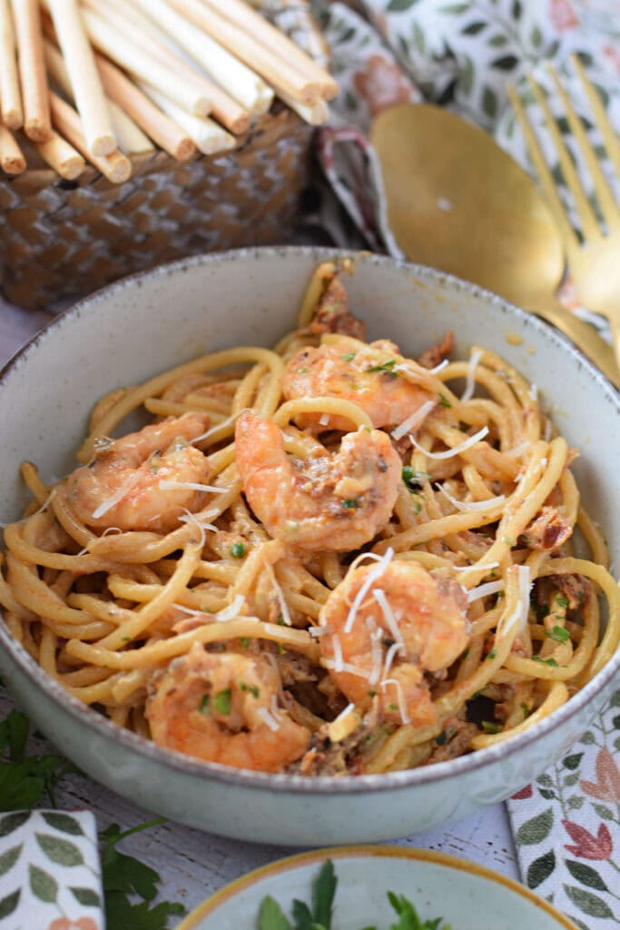Sun dried tomatoes in a creamy shrimp pasta dish.