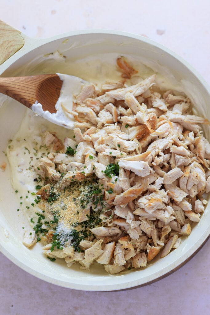 Making a creamy chicken filling.