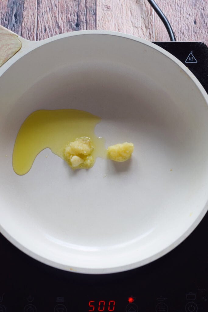 Heating olive oil in a skillet.