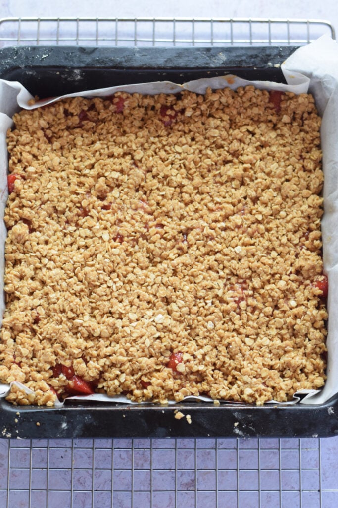 Baked strawberry crumble bars in a baking dish.