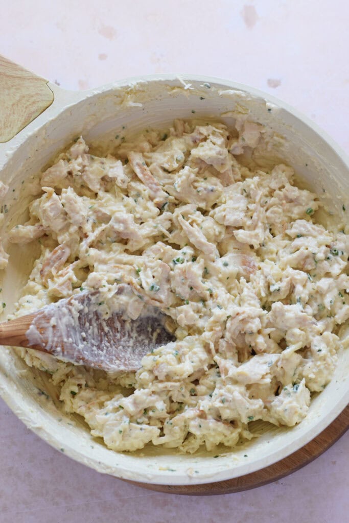 Making a creamy chicken filling in a skillet.