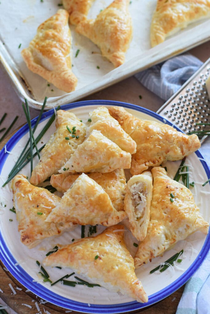 Chicken pastry bites on a white and blue plate.