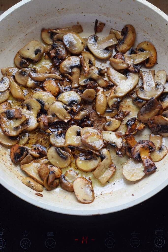 Cooking mushrooms in a skillet.