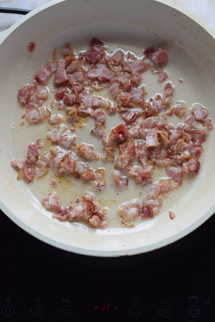 Cooking bacon in a skillet.