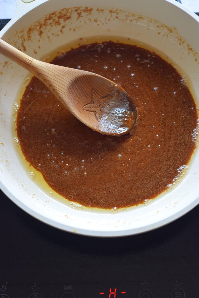 Cooking brown sugar and butter in a skillet.