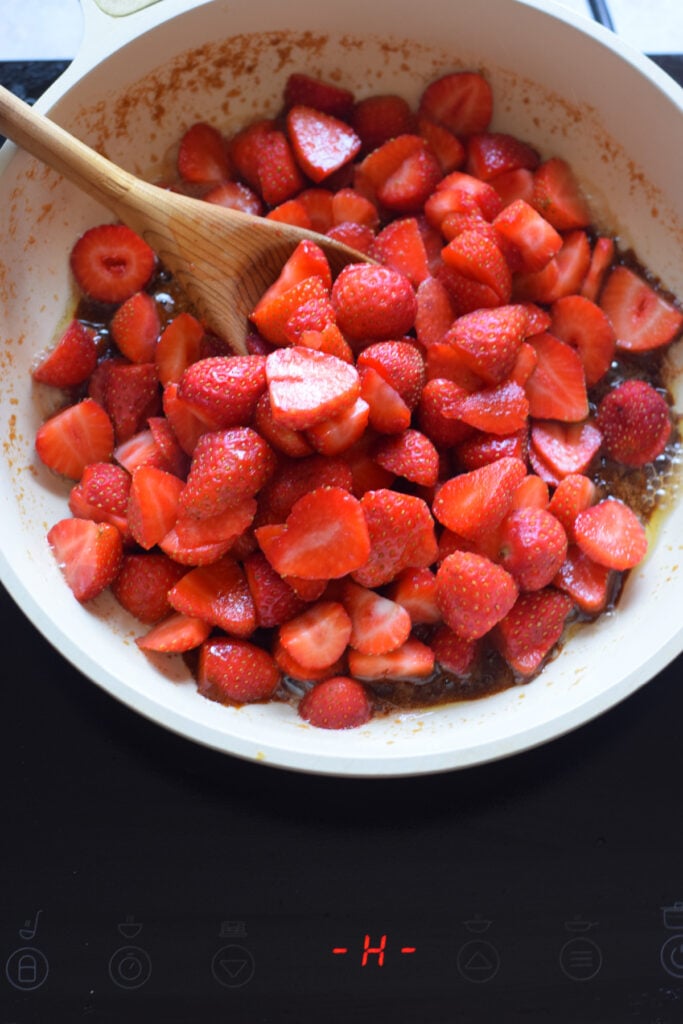Cooking strawberries in a skillet.