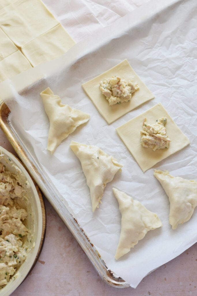 Making chicken puff pastry bites.
