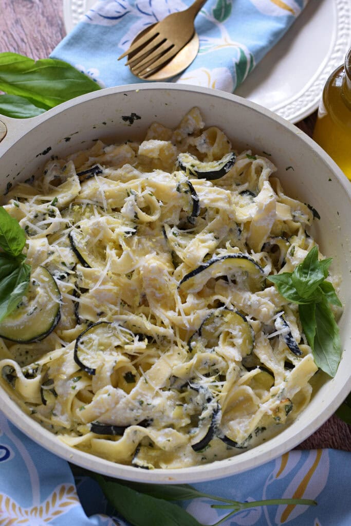 Zucchini pasta in a white skillet.