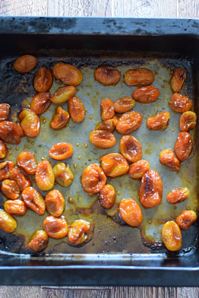 Roasted cherry tomatoes in a baking dish.