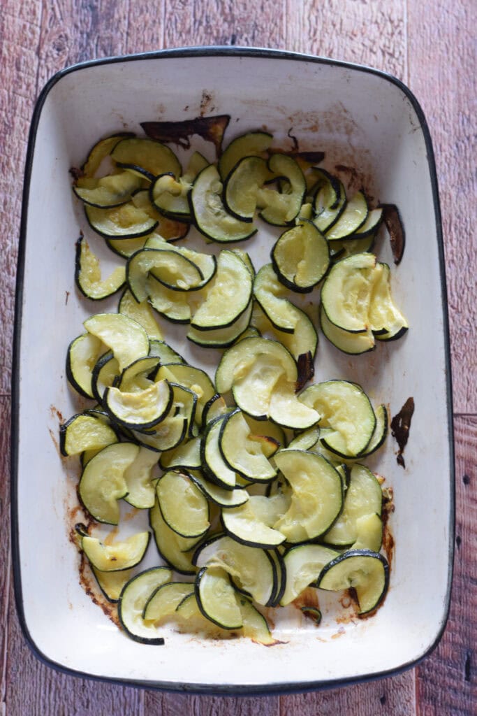 Roasted zucchini in a baking dish.
