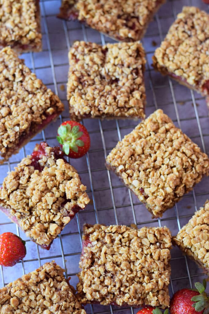 Strawberry crumble bars on a baking tray.
