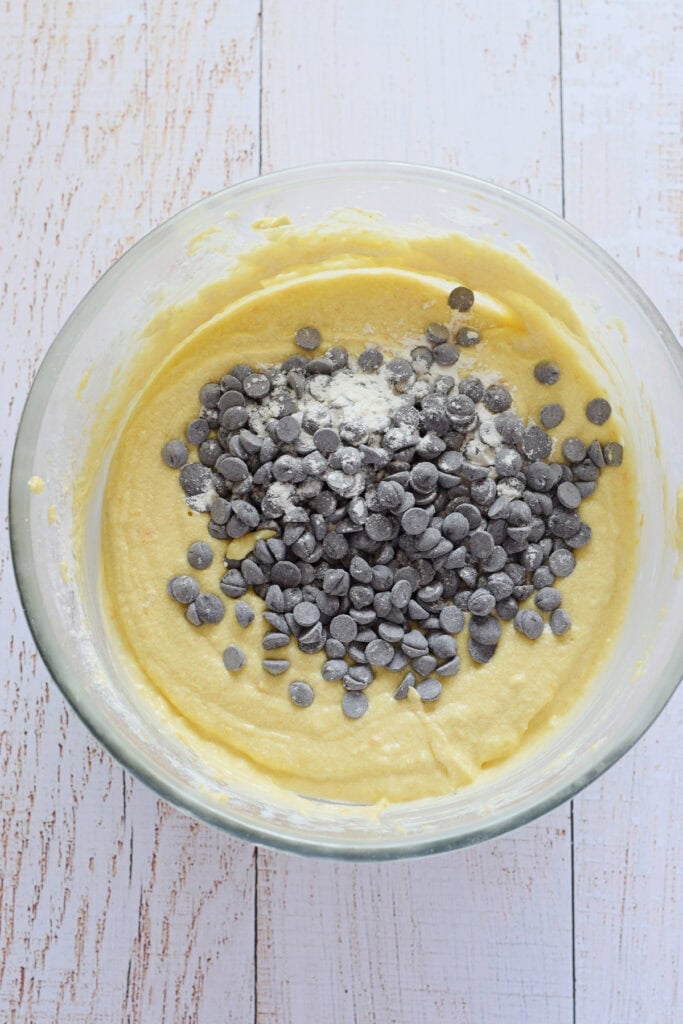 Adding chocolate chips to muffin batter.