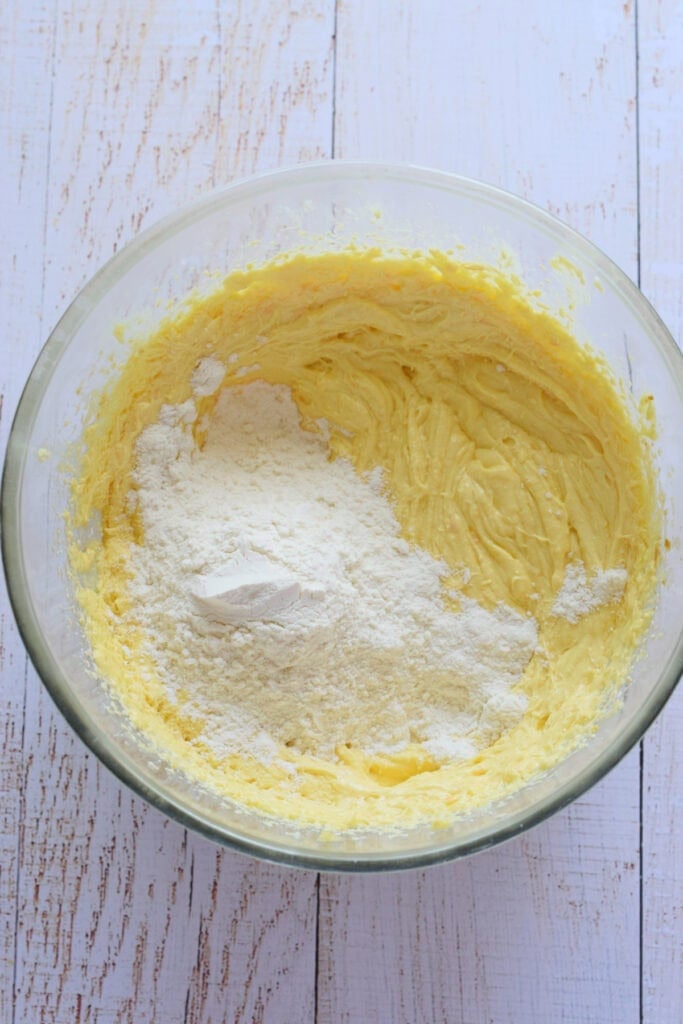 Adding flour to muffin batter.