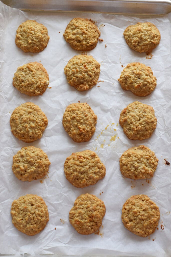 Baked oatmeal cookies on a baking tray.