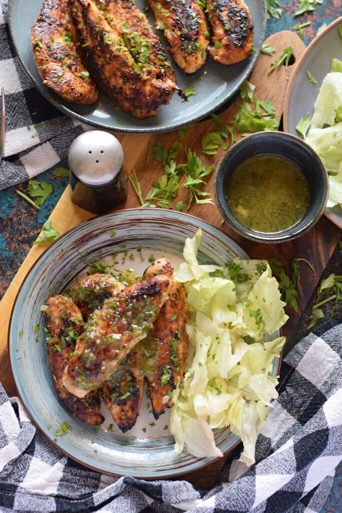 Chicken tenders on a plate with a honey mustard sauce.